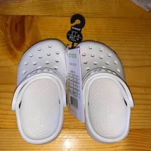 White children’s size 5 Crocs. They are brand new with tags, never been worn